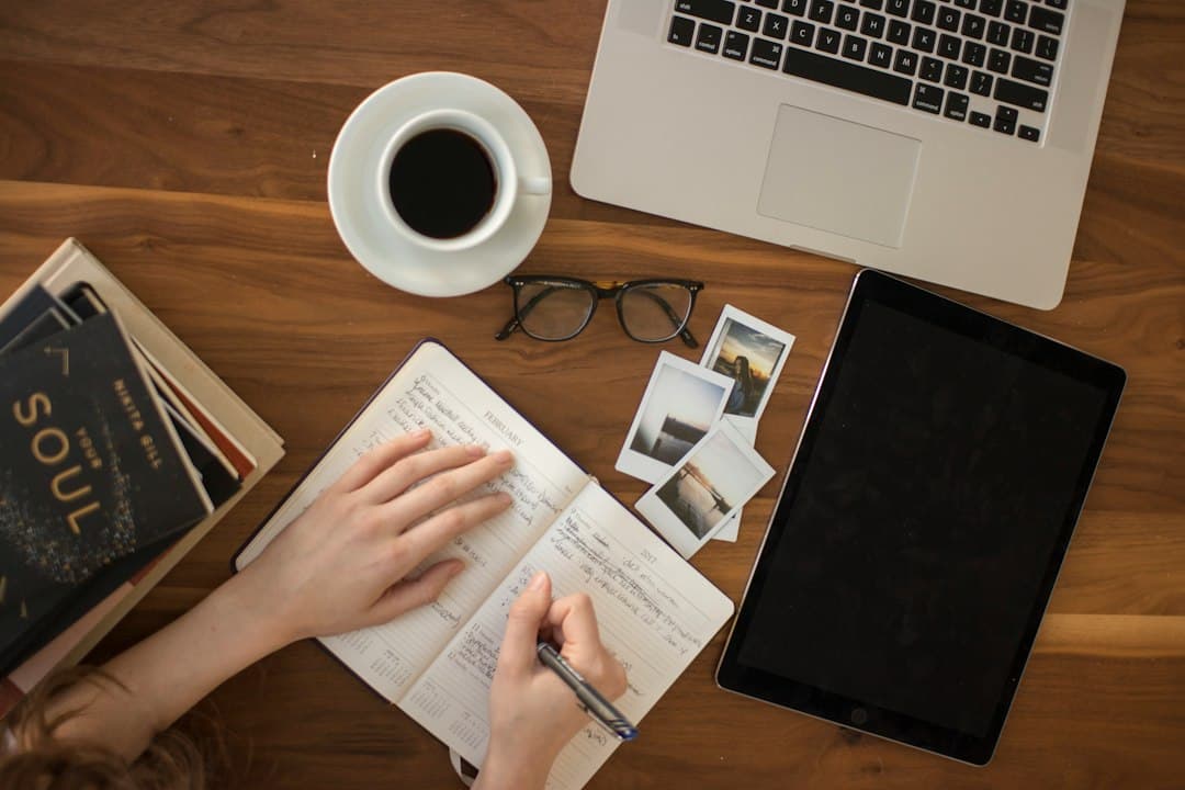 Person writing notes in a notebook during an editorial review
