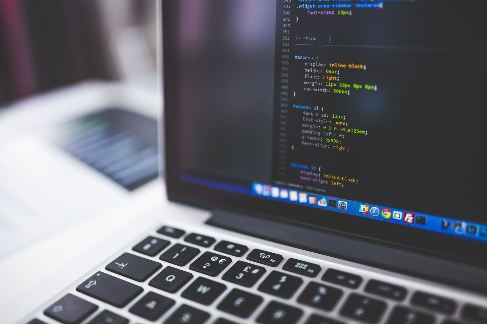 Laptop displaying web development code