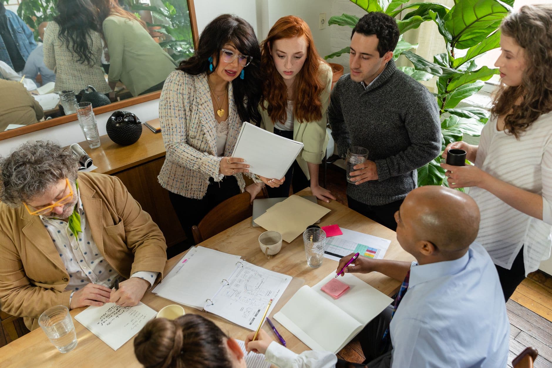 Colleagues reviewing documents together around a table