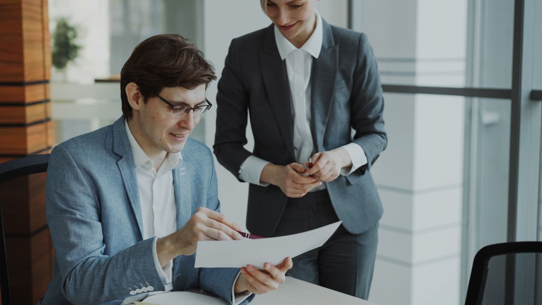 Colleagues reviewing a document together in an office