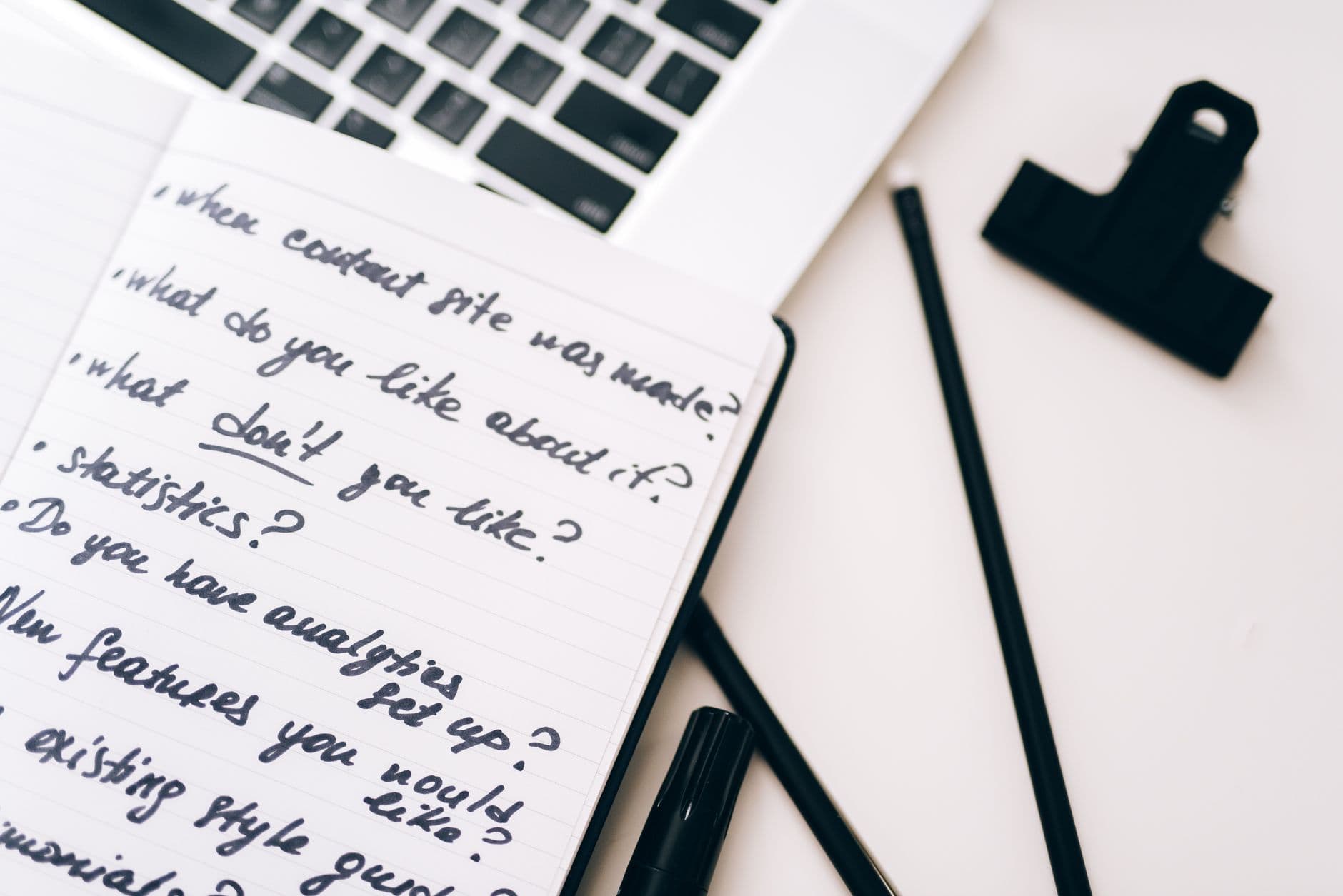 Notebook with handwritten notes beside a laptop for planning and strategy